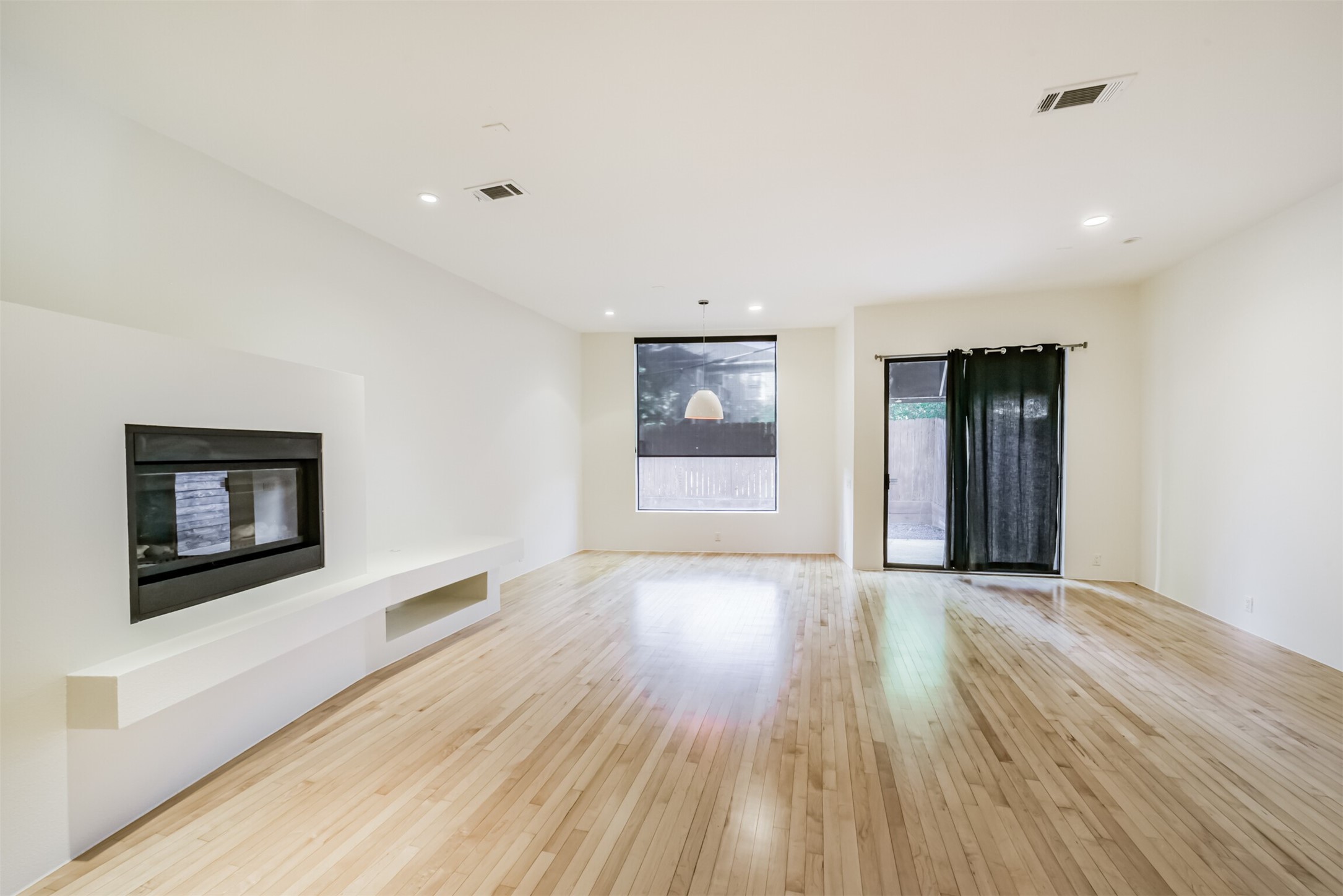 2518 Mason Street, Unit B Houston, TX 77006 - Photo 5 of 40 a view of an empty room with a window and wooden floor