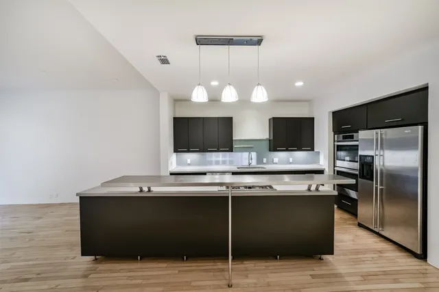 a kitchen with a sink cabinets and stainless steel appliances