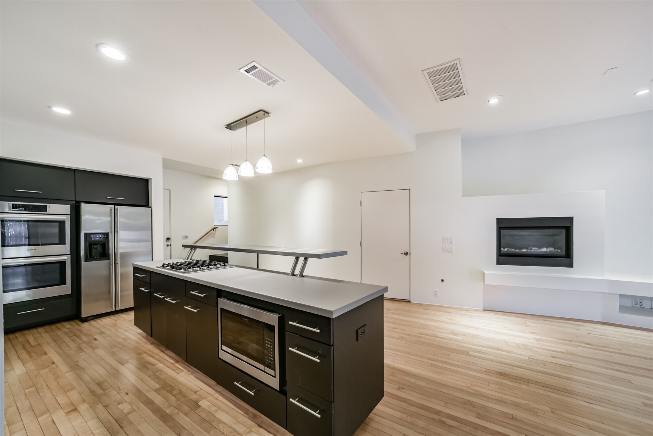 2518 Mason Street, Unit B Houston, TX 77006 - Photo 9 of 40 a kitchen with stainless steel appliances and wooden floor