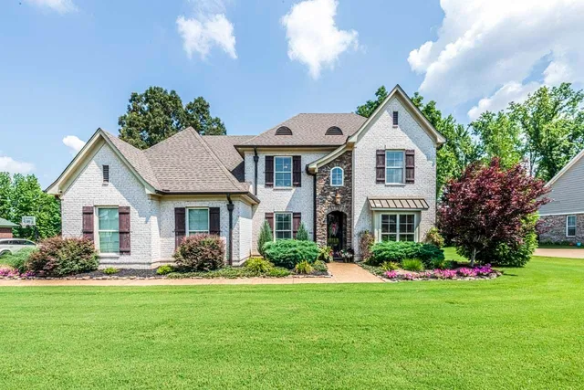 a front view of house with yard and green space