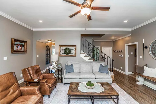 a living room with furniture and wooden floor