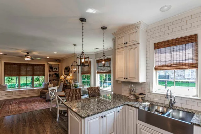 a kitchen with stainless steel appliances granite countertop a stove a sink dishwasher and a wooden cabinets