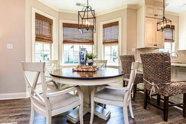 a view of a dining room with furniture wooden floor and chandelier