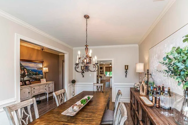 a view of a dining room with furniture wooden floor and chandelier