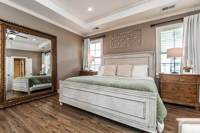 a bedroom with a large bed and a large window