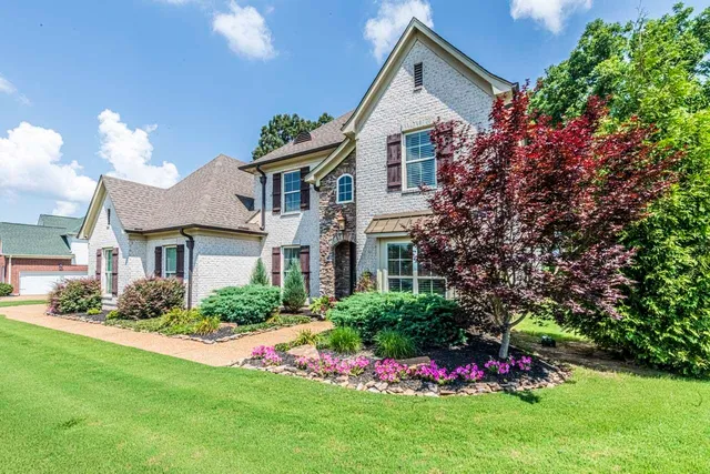 a front view of a house with a yard