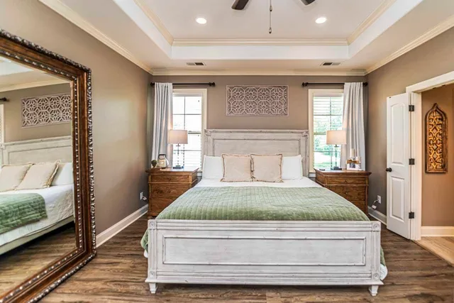 a bedroom with a bed and wooden floor