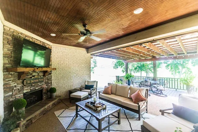 a outdoor living space with furniture and a flat screen tv