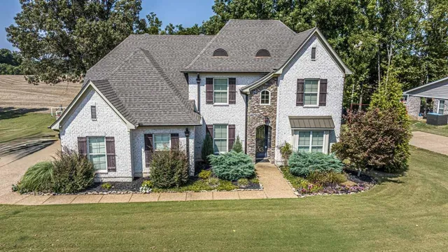 a front view of a house with a yard