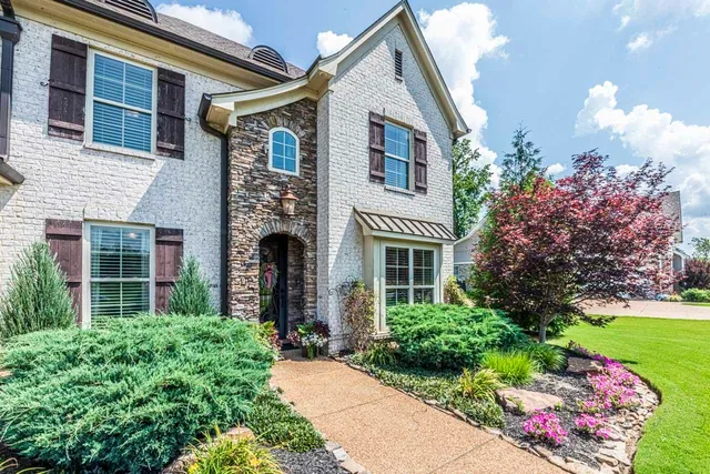 a front view of a house with garden
