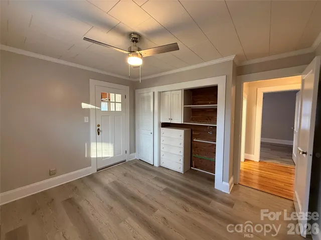 a room with wooden floor and furniture
