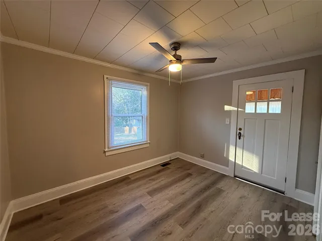 wooden floor in an empty room with a large window