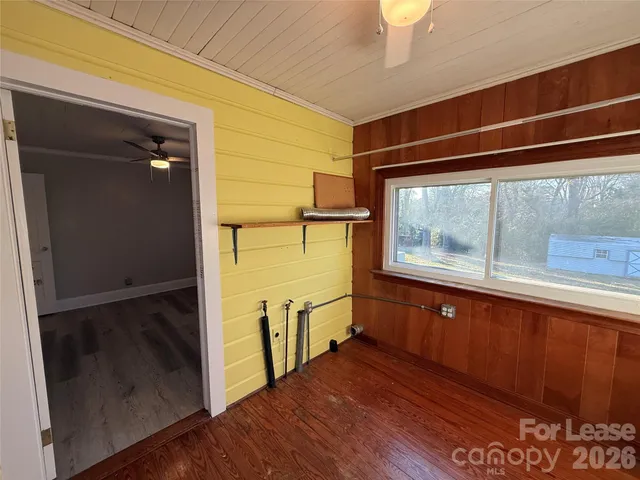 a view of a roof deck with wooden floor and fence