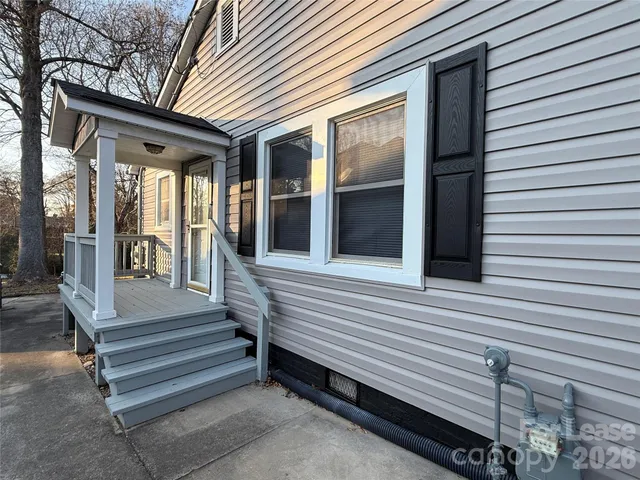 a view of a house with a door and wooden walls