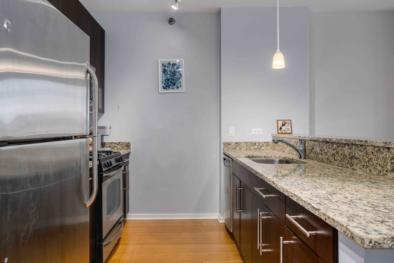 123 South Green Street, Unit 710B Chicago, IL 60607 - Photo 12 of 17 a bathroom with a granite countertop sink and a mirror