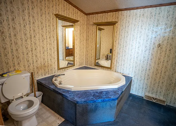 a white bath tub sitting next to a toilet