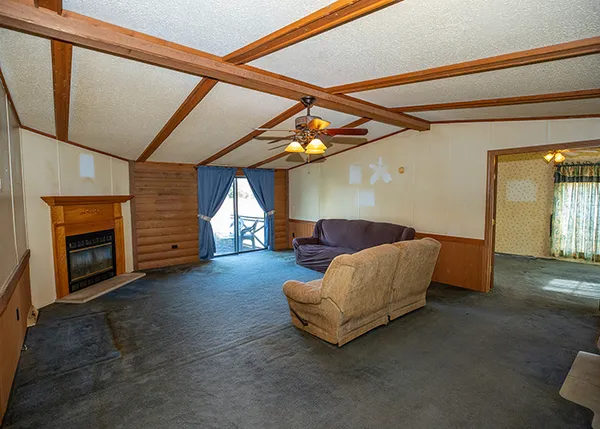 a living room with furniture and a ceiling fan