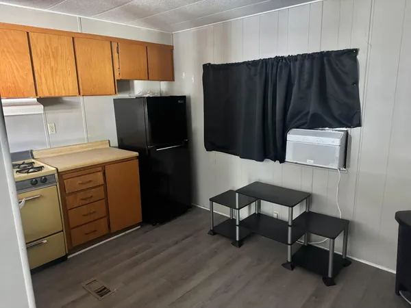 a kitchen with a cabinets and a refrigerator