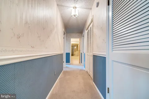 an empty room with a cabinet and mirrors