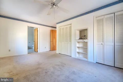 a view of an empty room and closet area