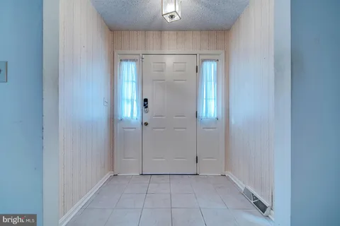 a view of a kitchen with a sink and dishwasher a stove top oven with wooden floor