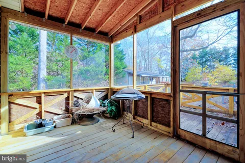 a front view of a house with yard porch and tree