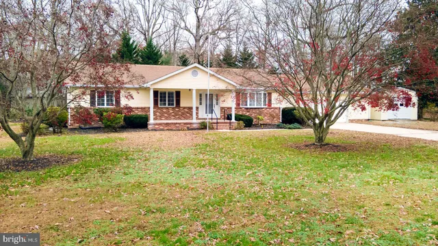 a view of the house with snow on the road