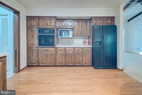 a view of a kitchen from a hallway