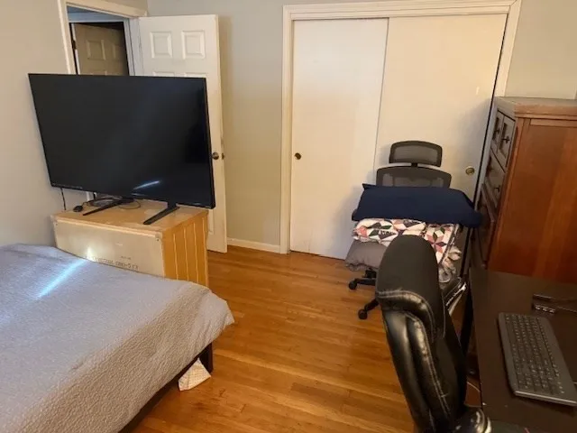 a bedroom with a bed and flat screen tv