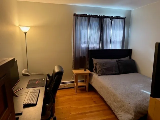 a bedroom with a bed a desk and chair