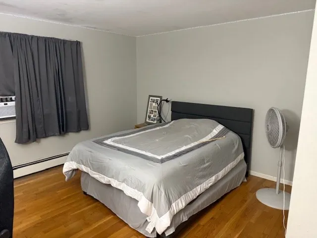 a bed sitting in a bedroom next to a cabinet