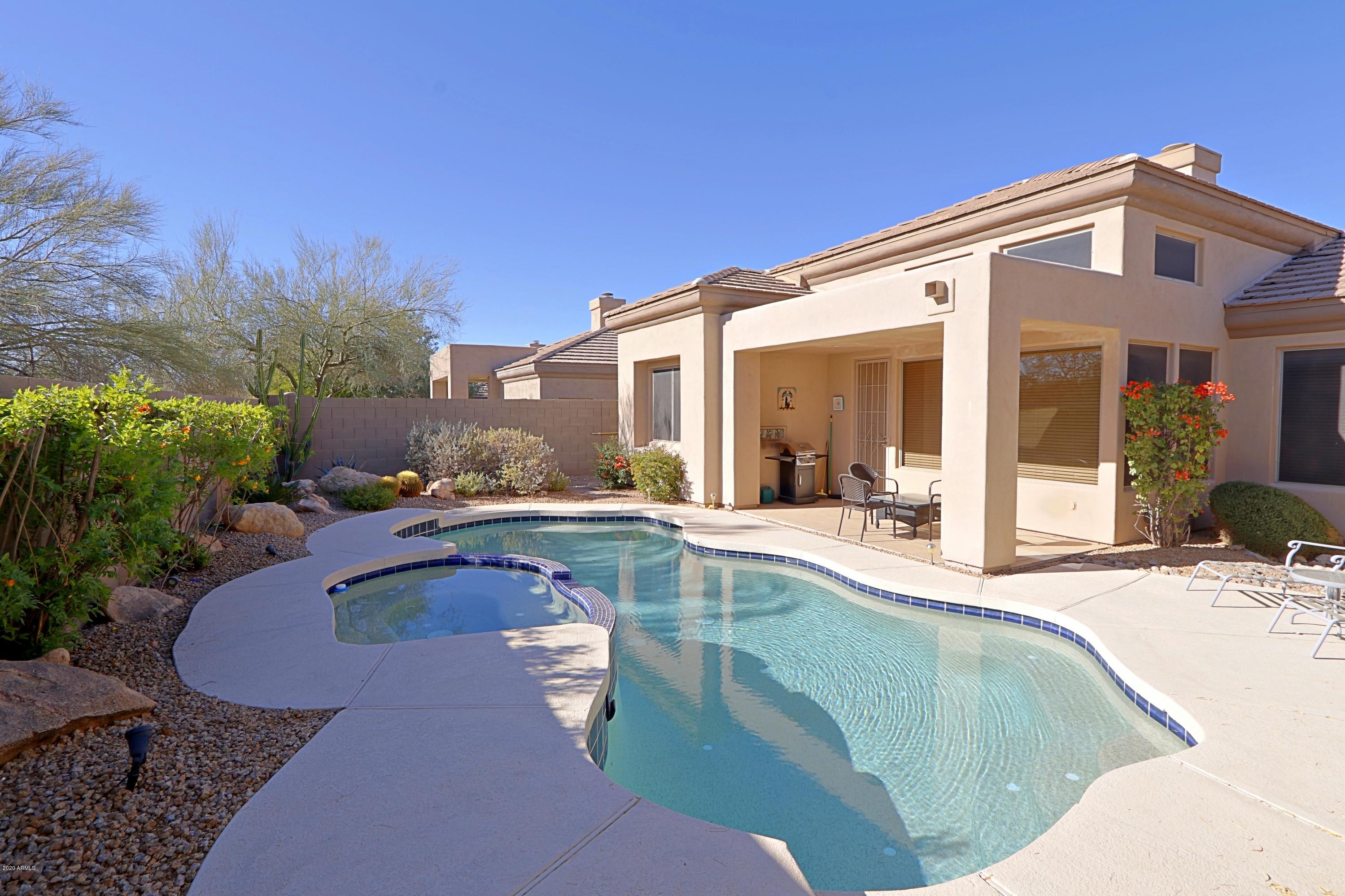 6803 East Eagle Feather Road Scottsdale, AZ 85266 - Photo 29 of 67 a view of a house with swimming pool and sitting area