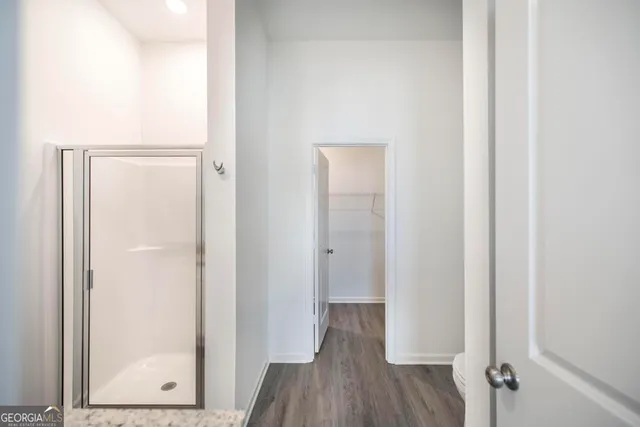 a view of a hallway with wooden floor