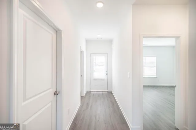 a view of a hallway with wooden floor