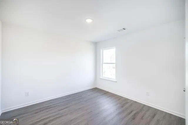 a view of kitchen view wooden floor and electronic appliances