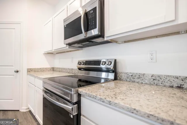 a kitchen with a stove and a microwave