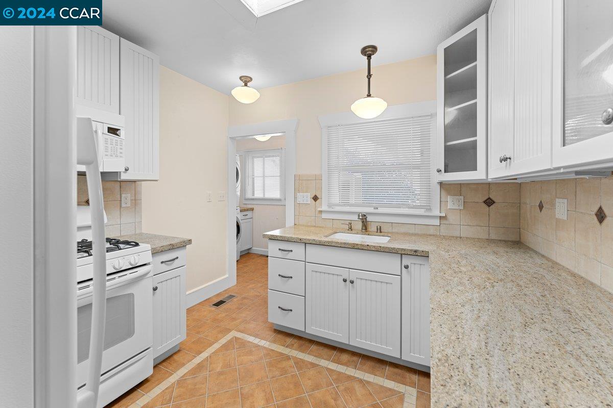 2820 Kelsey Street Berkeley, CA 94705 - Photo 9 of 23 a large white kitchen with cabinets