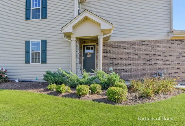 a front view of a house with a garden