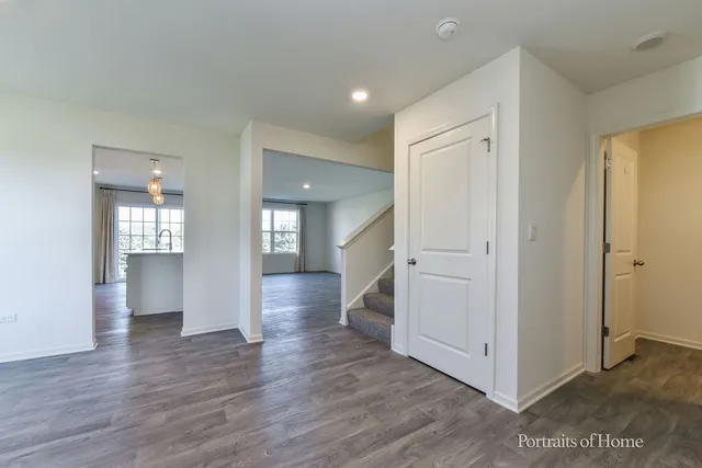 a view of kitchen with refrigerator and wooden floor
