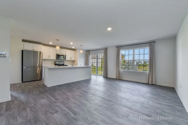 a kitchen with refrigerator a stove and furniture