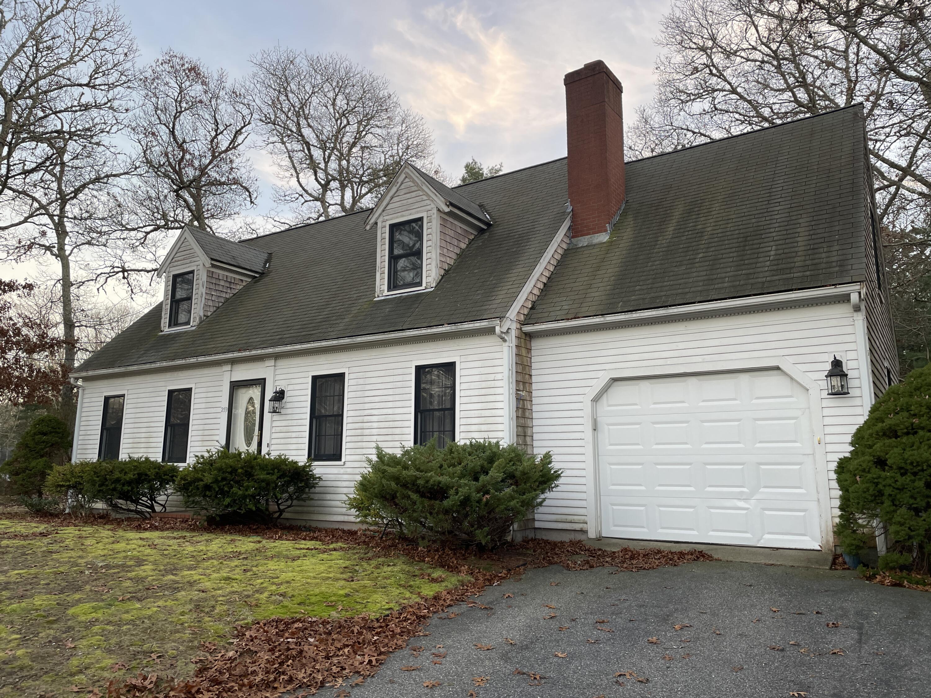 259 Great Marsh Road Centerville, MA 02632 - Photo 1 of 12 a front view of a house with garden
