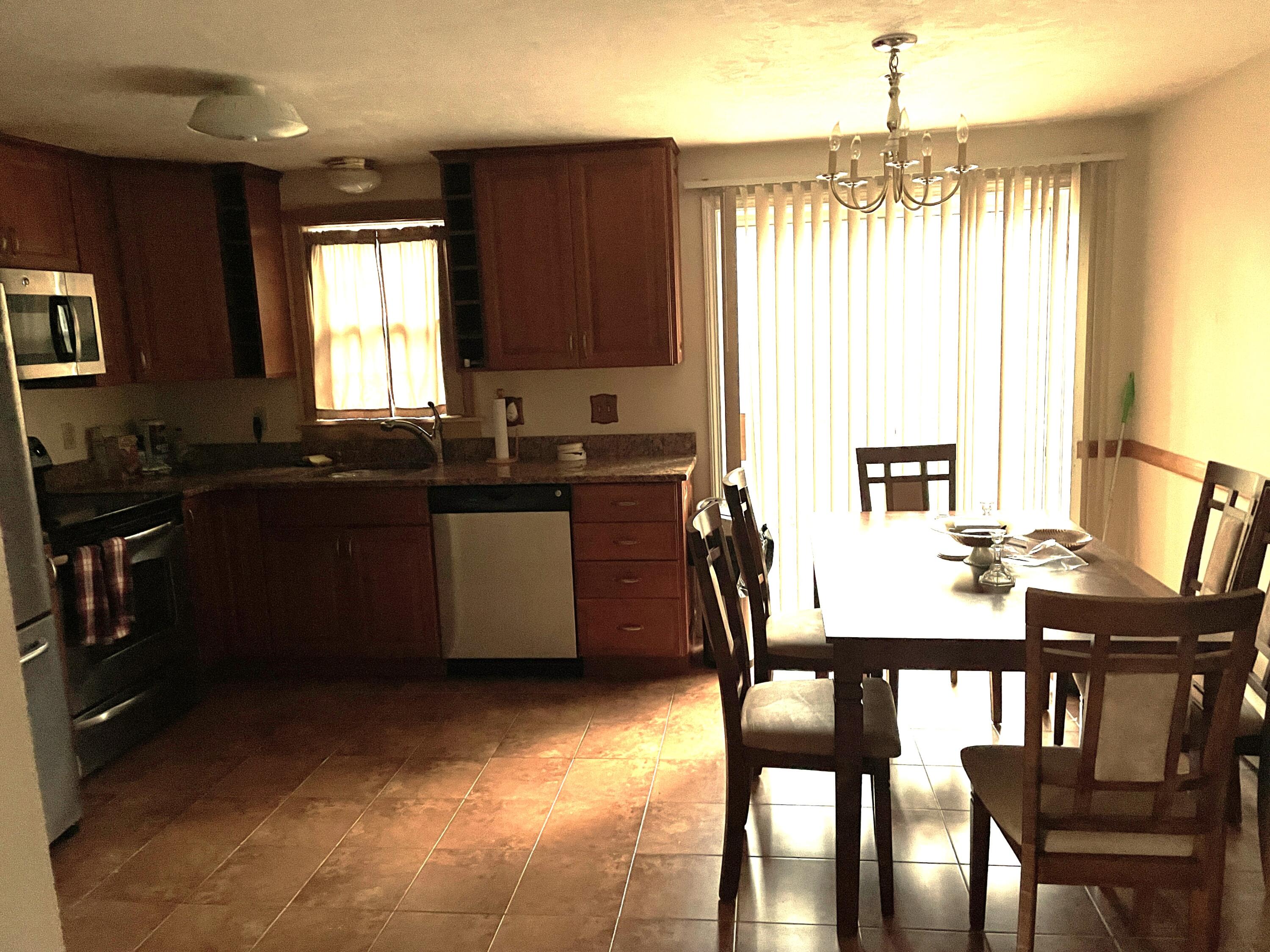 259 Great Marsh Road Centerville, MA 02632 - Photo 11 of 12 a kitchen with a table chairs sink and cabinets