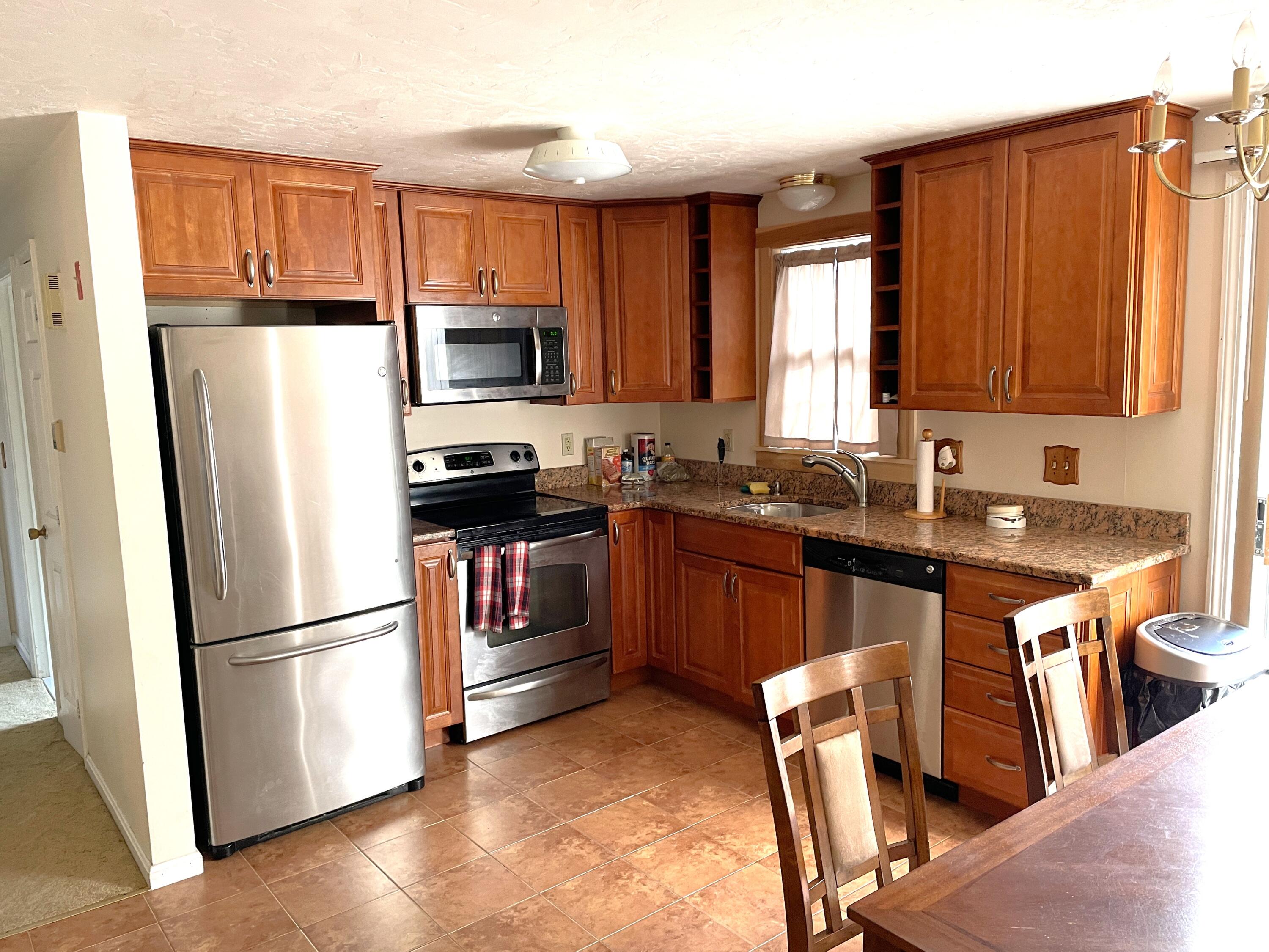 259 Great Marsh Road Centerville, MA 02632 - Photo 2 of 12 a kitchen with stainless steel appliances granite countertop a refrigerator stove microwave and sink
