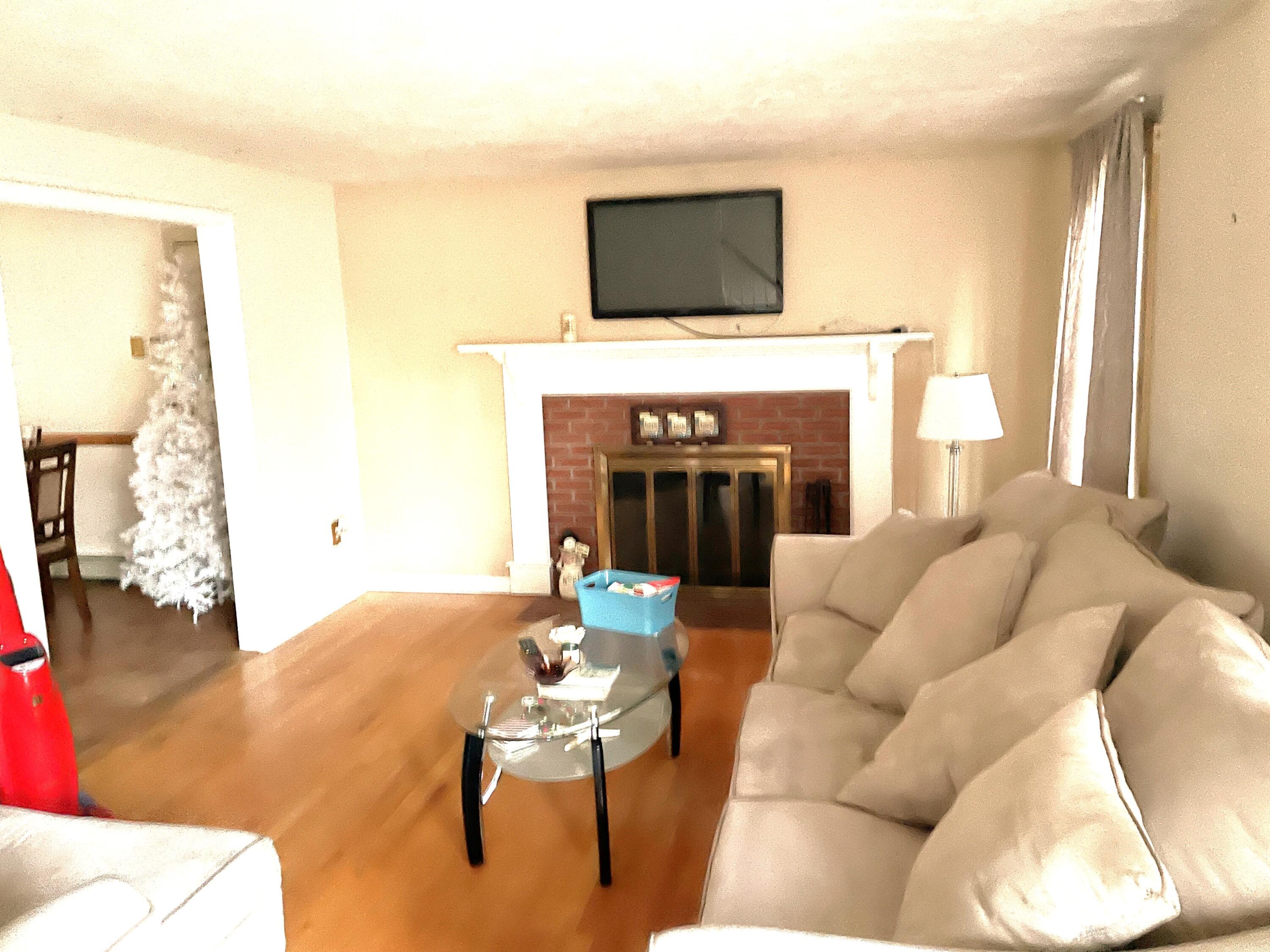 259 Great Marsh Road Centerville, MA 02632 - Photo 3 of 12 a living room with furniture a fireplace and a flat screen tv