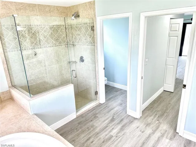 a bathroom with a tub and shower
