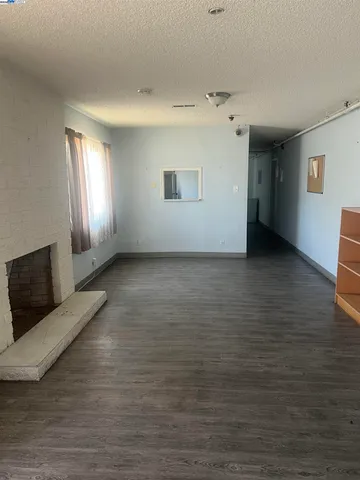 a view of a livingroom with wooden floor and window