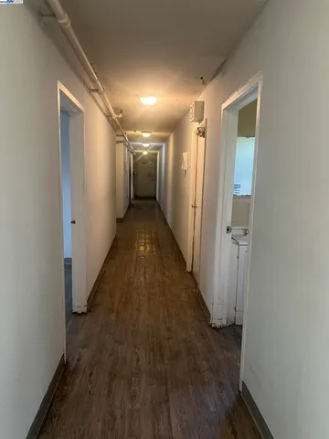 a view of a hallway with wooden floor