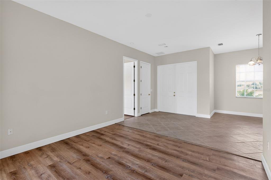 1216 Heavitree Court Sebring, FL 33876 - Photo 13 of 35 a view of empty room with wooden floor and fan