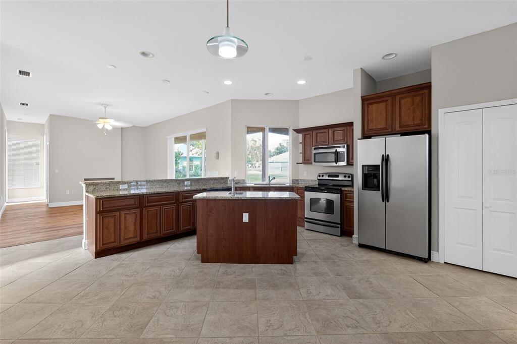 1216 Heavitree Court Sebring, FL 33876 - Photo 17 of 35 a large kitchen with stainless steel appliances and a refrigerator