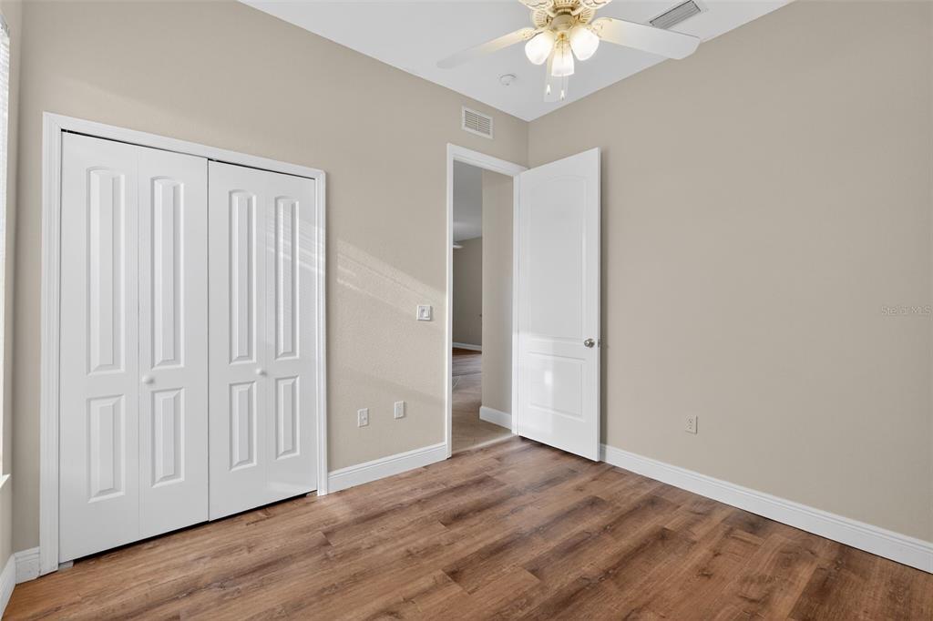 1216 Heavitree Court Sebring, FL 33876 - Photo 20 of 35 a view of an empty room with wooden floor